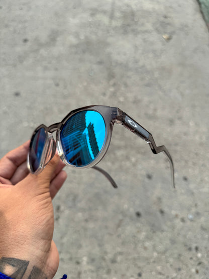 Gafas Oakley HSTN transparente lente azul prizm